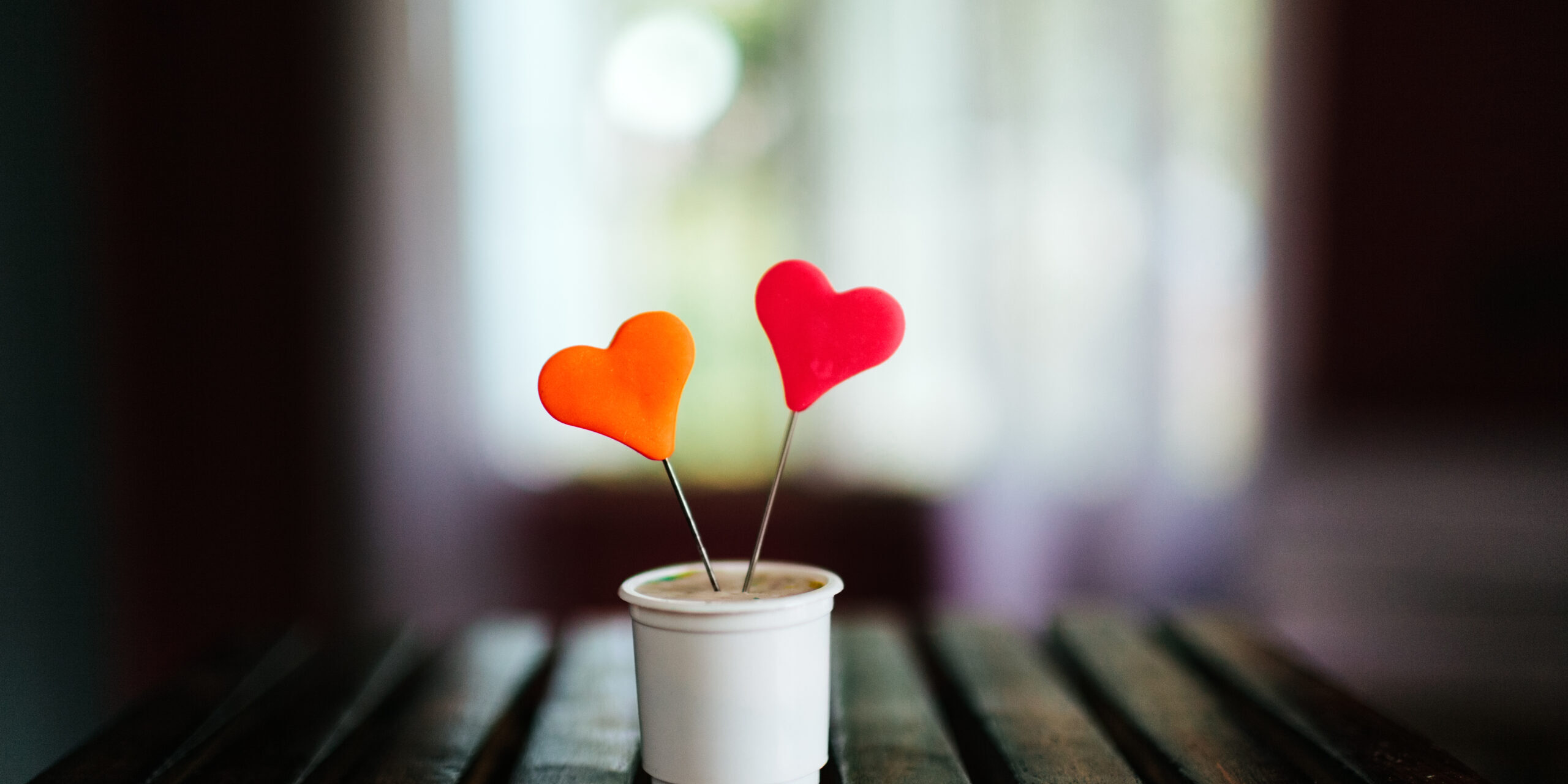 Closeup shot of a muffin with colorful hearts on it